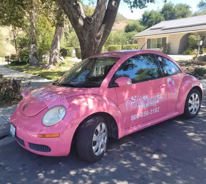 Pink Sponge company car with branding painted on the side